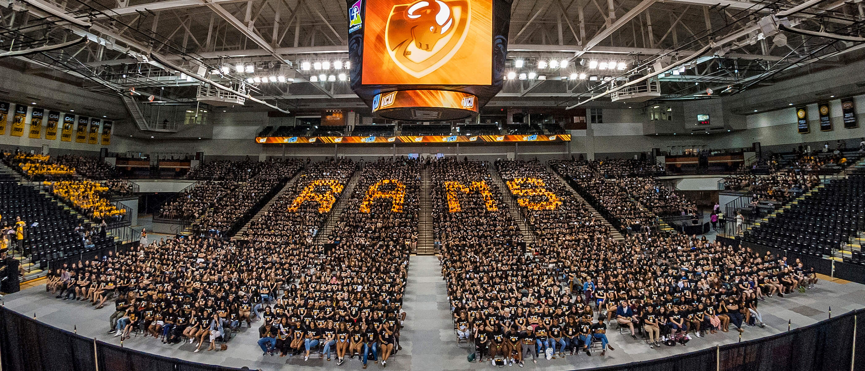 Students gather in a large arena for convocation