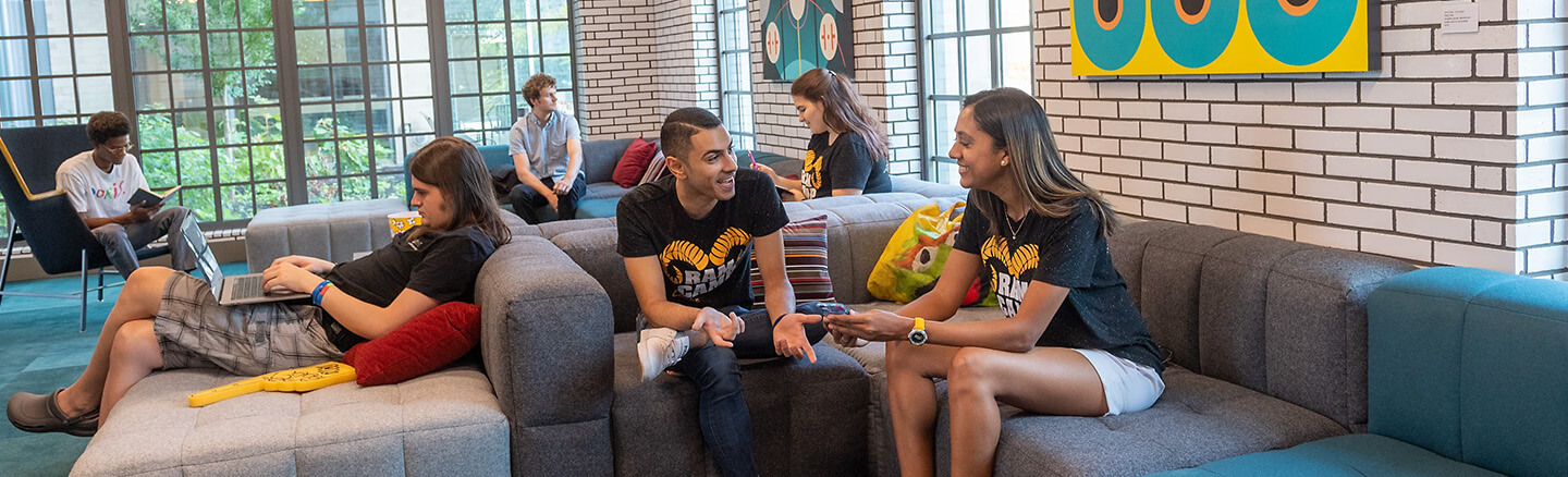 Students having a conversation inside a residence hall